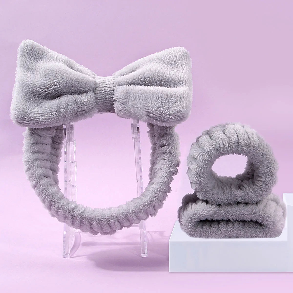 Three-piece facial skincare set showing a nylon brush and a coral fleece hair band in purple.