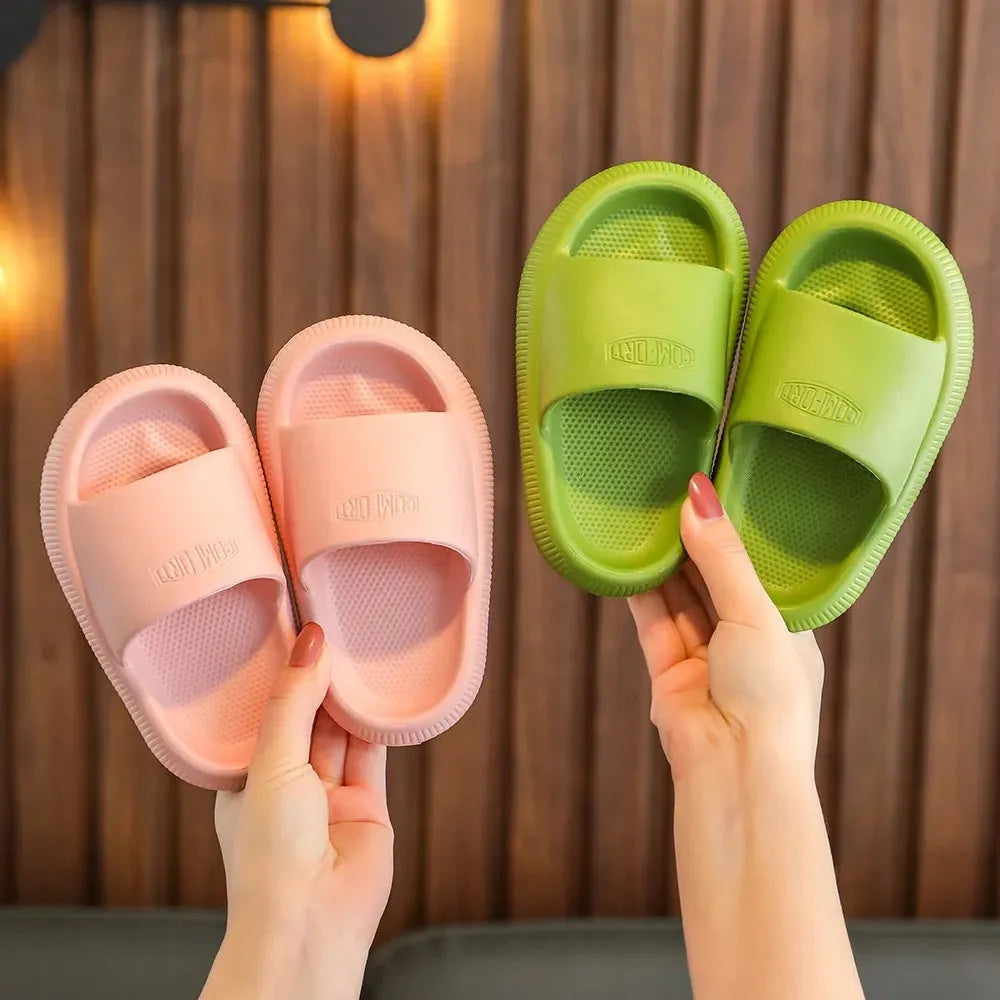 Children's mixed colour EVA slippers with textured sole, shown in blue, green, orange, pink, and yellow.