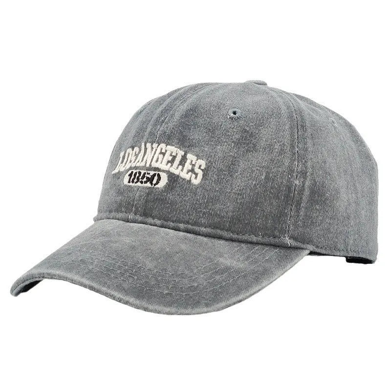 Distressed beige baseball cap with embroidered letters on the front, showing adjustable strap and curved 7cm peak.