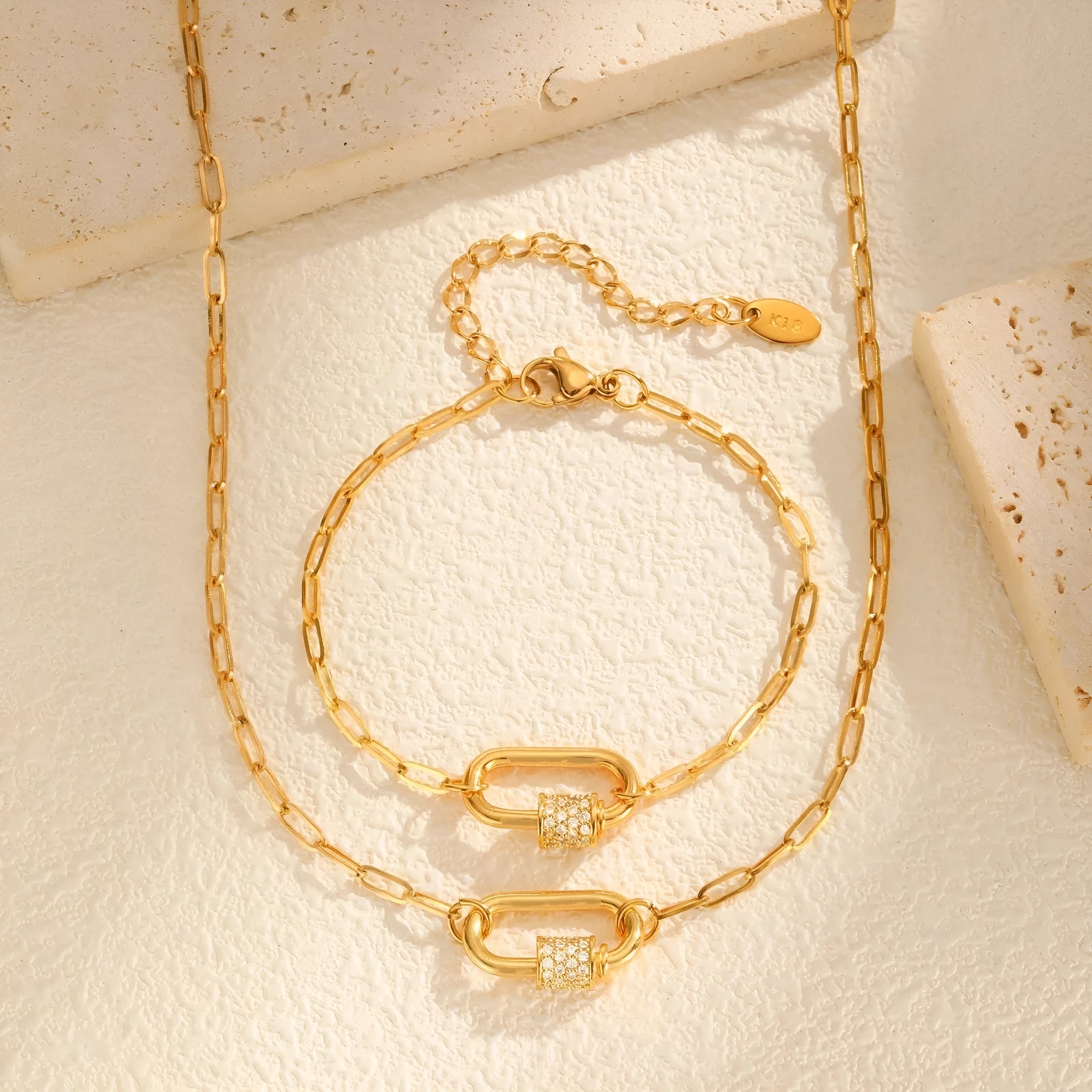 Gold electroplated stainless steel small square chain necklace with oval zircon pendant on a light background