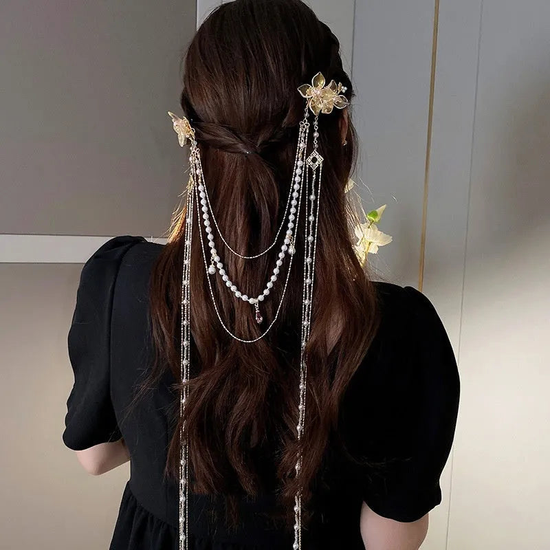 Gold-coloured women's hairpin with acrylic flower design featuring pearl, diamond, and long tassel decorative elements