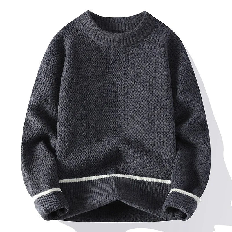 Man wearing a grey loose-fit round neck long sleeve pullover sweater.