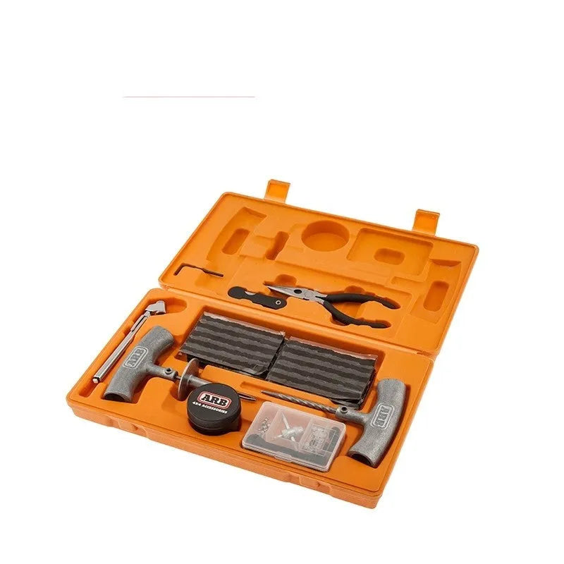 Open case showing emergency car tyre repair tool set with pressure gauge, pliers, and insertion tools.