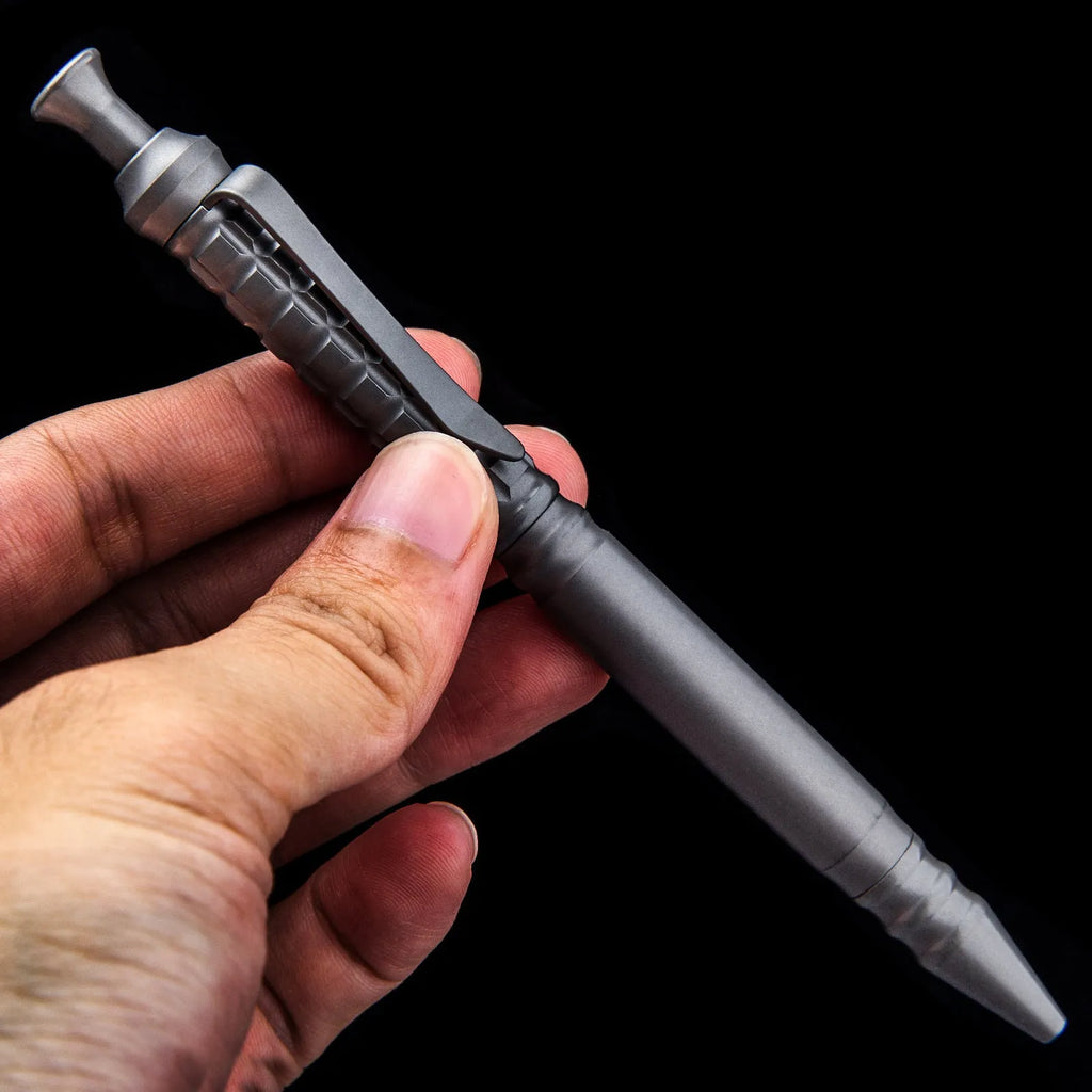 Gunmetal grey titanium alloy tactical pen with push-action decompression mechanism