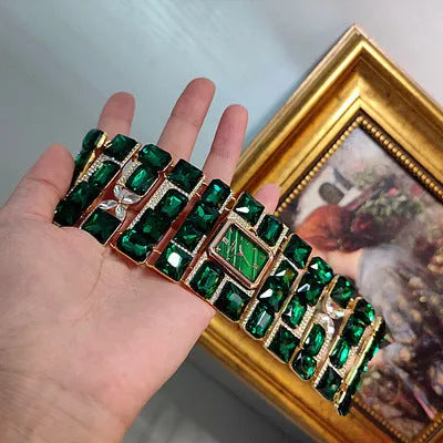 Antique court retro bracelet watch with emerald colored glaze round face and alloy bracelet
