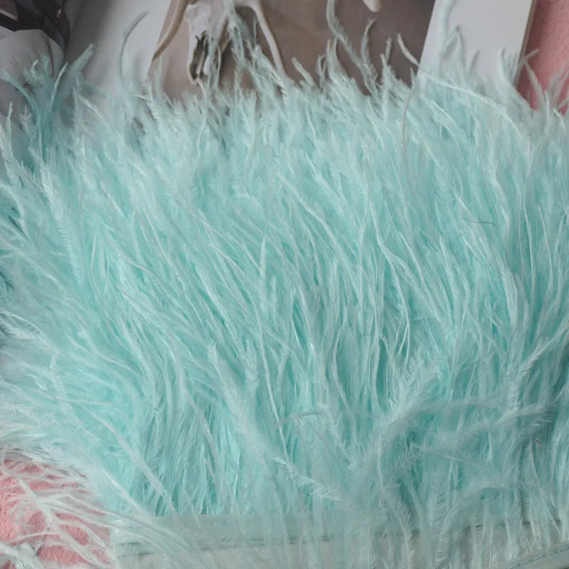 Decorative feather cloth strip in multiple colours including white, black, and mint green for DIY clothing and craft projects