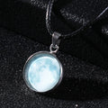 Close-up of a luminous alloy necklace with a glass pendant featuring a Christmas moon night sky and constellation design.