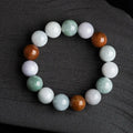 Close-up of a women's bracelet with round 13mm Myanmar jade beads in three colours.