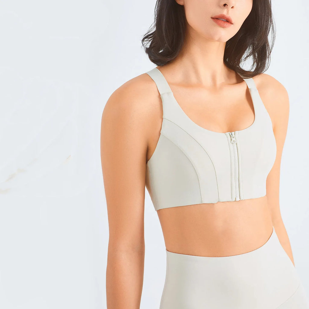 Zip front sports bra in pink lychee colour showing racerback shape and mesh back panel