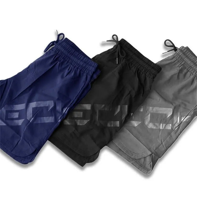 Men's knee-length training shorts with elastic waist in black, dark grey, navy blue or white