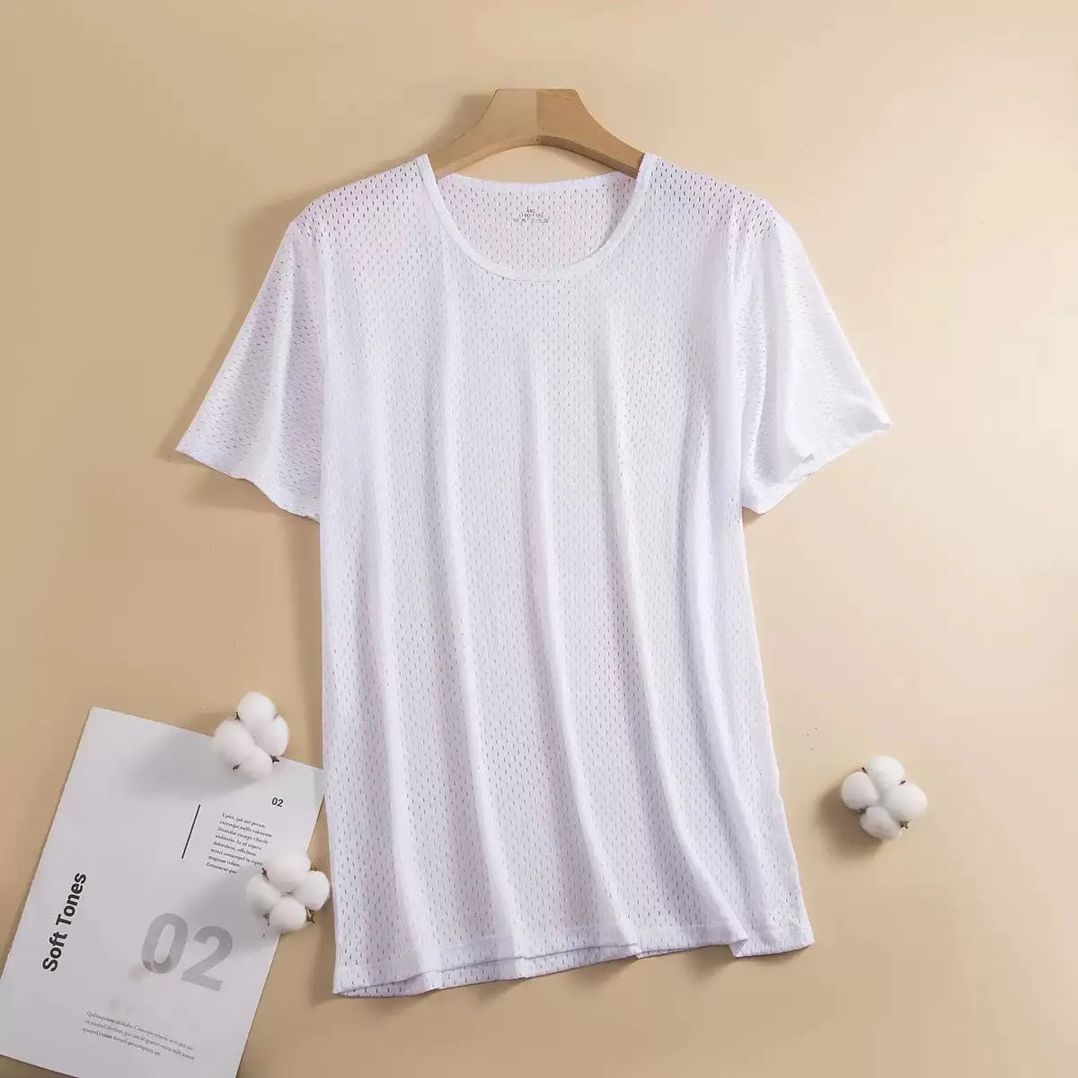 Men's solid colour ice silk short sleeve t-shirt in loose fit on a hanger.