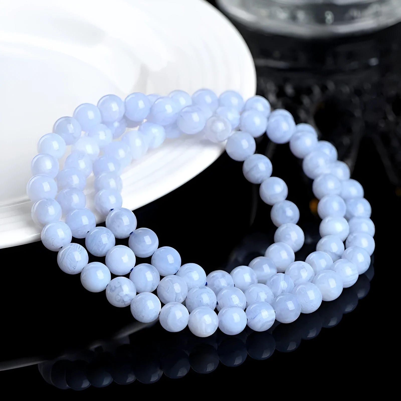 Blue agate beaded bracelet with three strands and a silver Ruyi-style clasp.