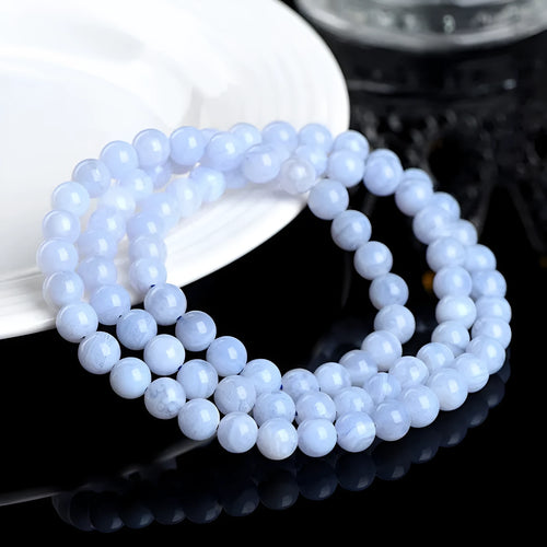 Blue agate beaded bracelet with three strands and a silver Ruyi-style clasp.