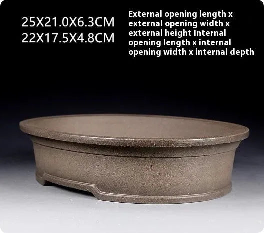 Handmade oval purple sand ceramic bonsai flower pot measuring 25 by 21 by 6.3 centimetres.
