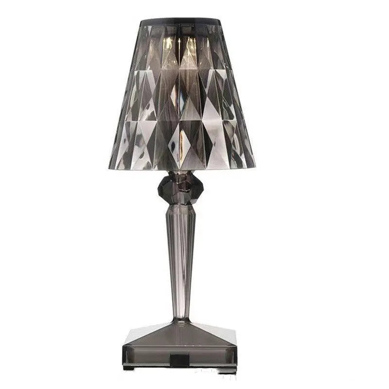 Rose gold plated portable touch night light with acrylic body on a surface.