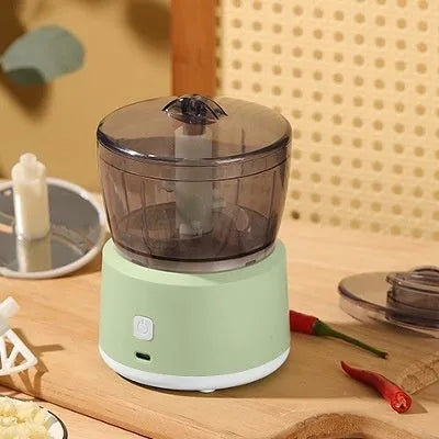 Mini electric meat grinder with transparent 225ml cup and stainless steel blades in light green colour