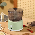 Mini electric meat grinder with transparent 225ml cup and stainless steel blades in light green colour