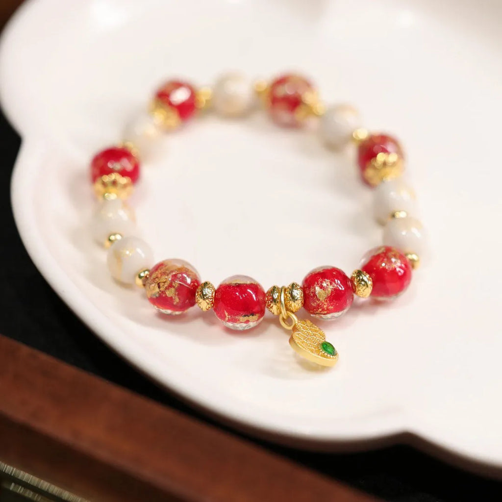 Women's ethnic geometric bracelet with gold foil decoration on glass and coloured glaze in two colour options.