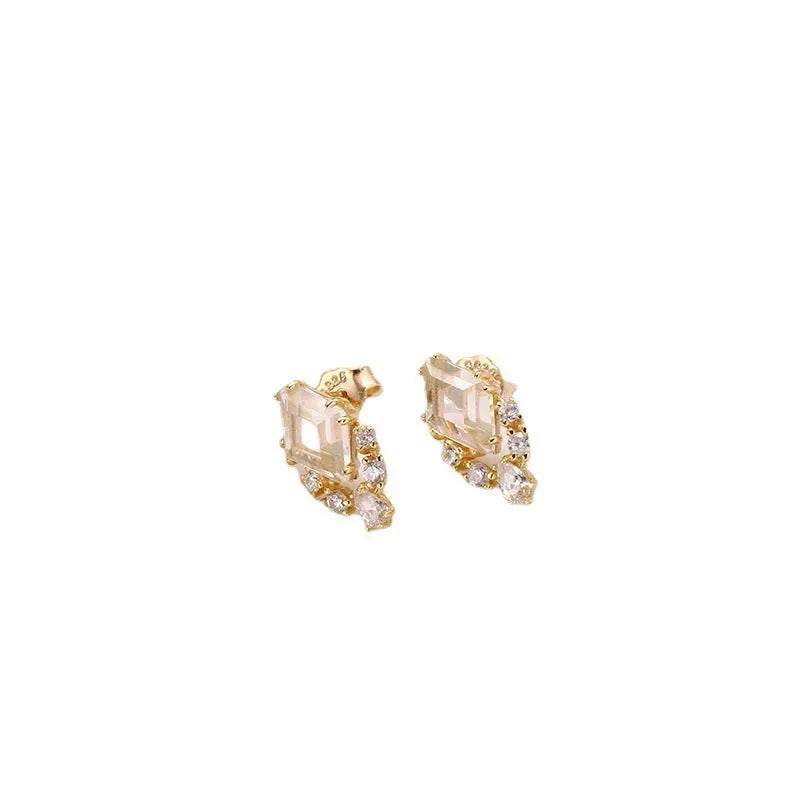Geometric 925 silver ear studs with natural white crystal accents on simple background