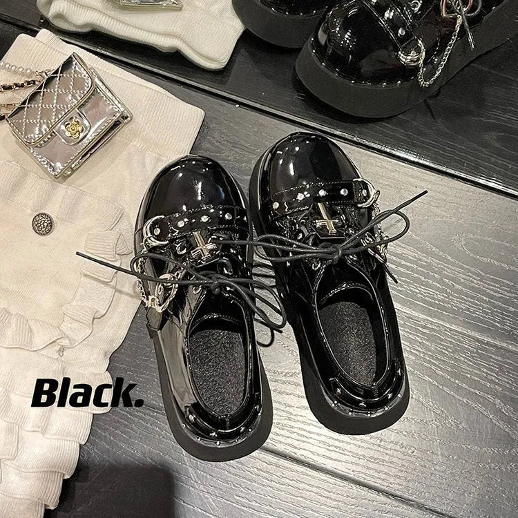Solid black punk platform shoes with leather upper, rubber sole, and visible stitching detail