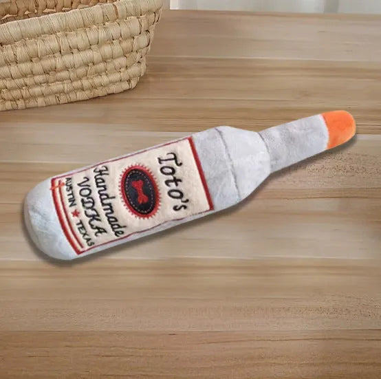 Brown plush wine bottle shaped dog toy with squeaker