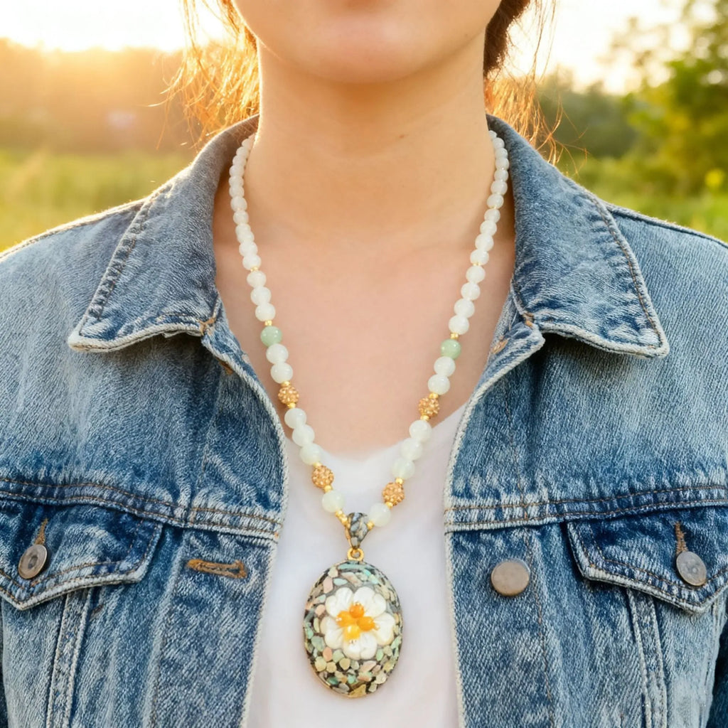 Original design mother-of-pearl lacquer shell necklace with rhinestone twist chain on display