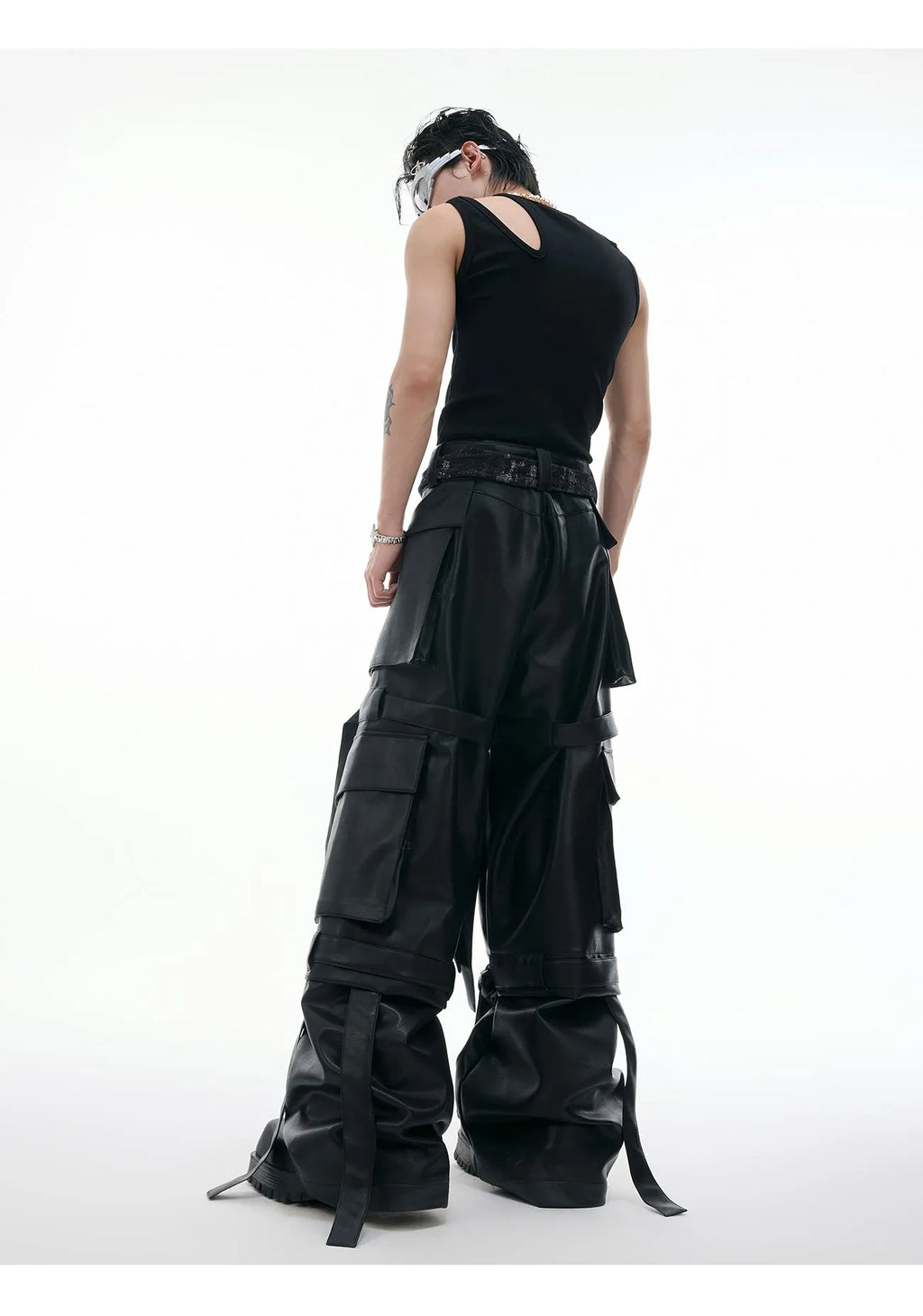 Black loose-fit quilted trousers with multiple pockets on a mannequin.