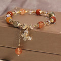 Coloured hair crystal bracelet with cat's paw and butterfly charms in Korean unisex style
