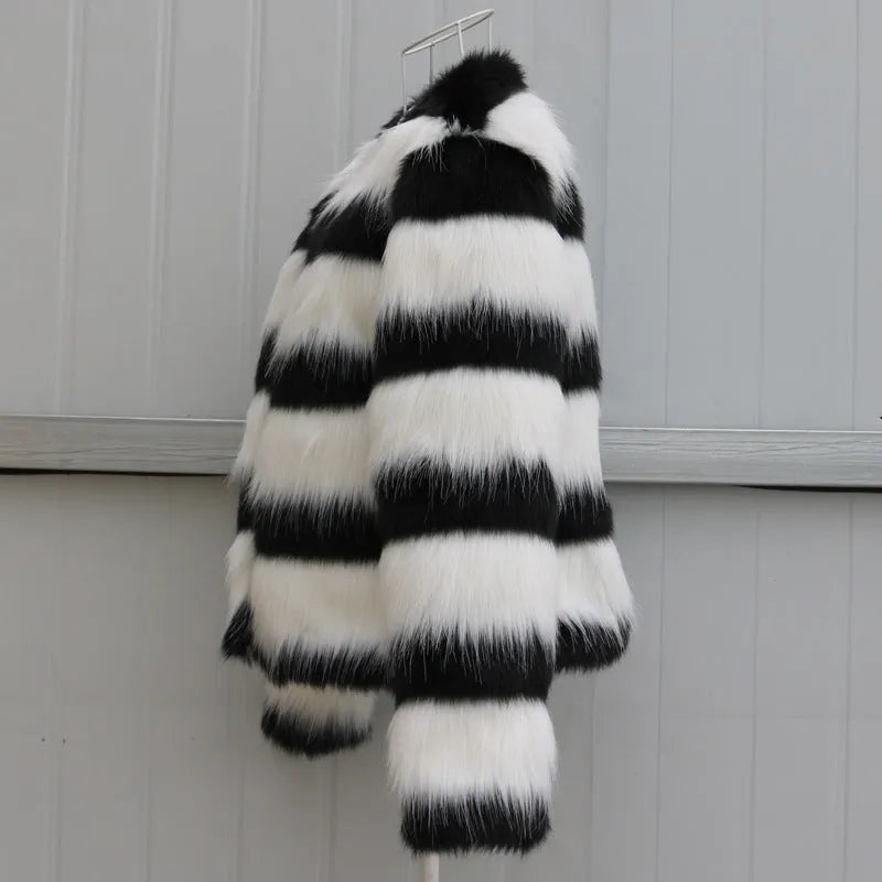 Womens black and white striped faux fur leather jacket with long sleeves on a model.