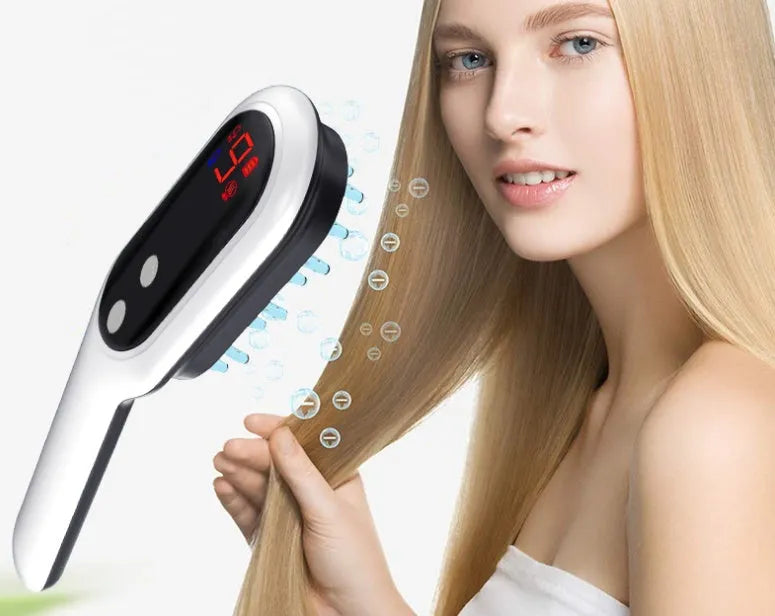 White electric head massager comb with red and blue light therapy, magnetic contacts, and LED display on a clean background