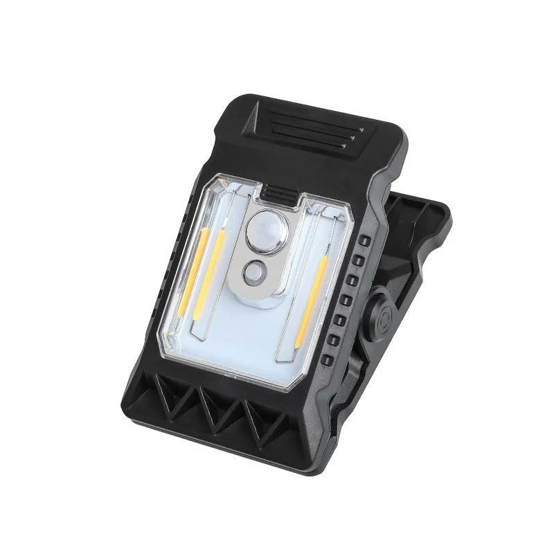 White intelligent motion sensor clip lamp mounted on a shelf edge.