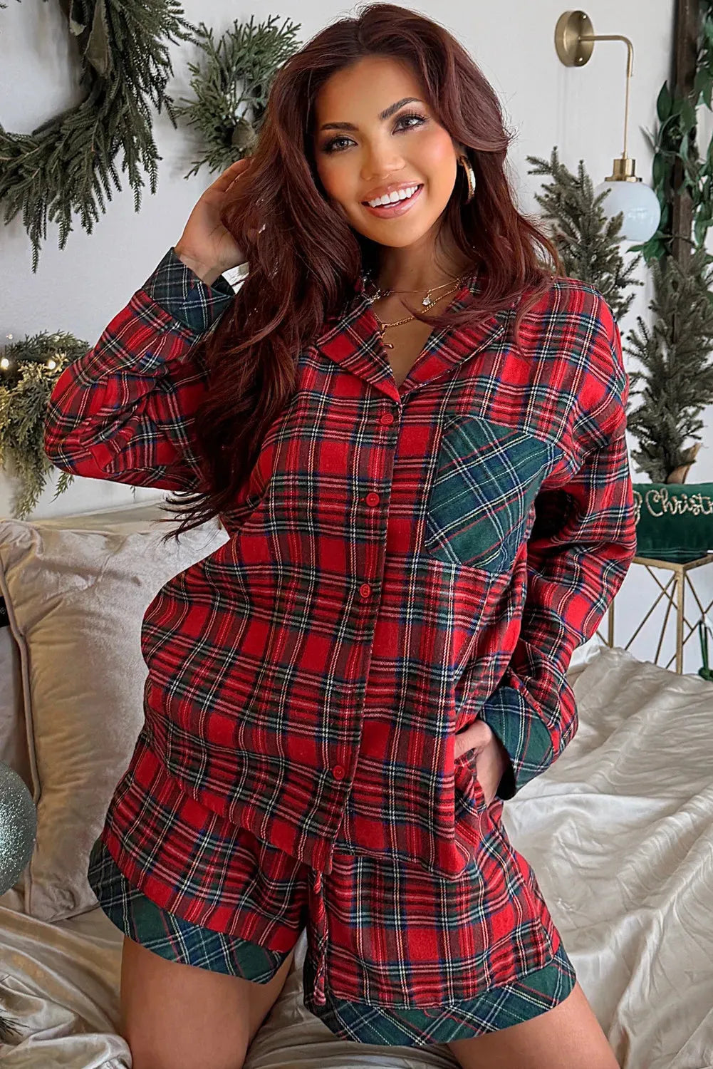 Red plaid Christmas pyjama set with contrast patches, showing long sleeve shirt and shorts laid flat.