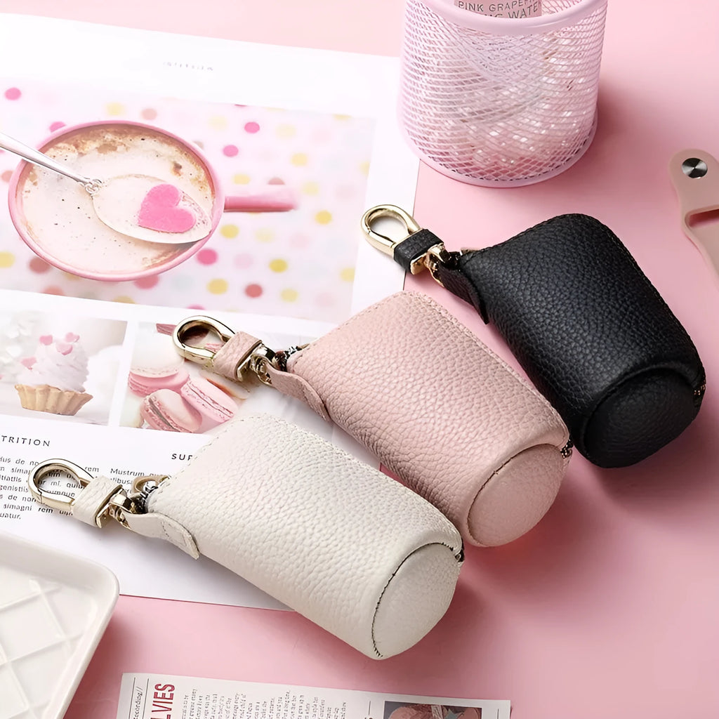 Black pu leather key case with silver zipper closure showing key ring inside