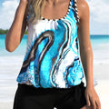 Blue tie-dye patterned two-piece swimsuit for women on a mannequin, showing top and shorts.
