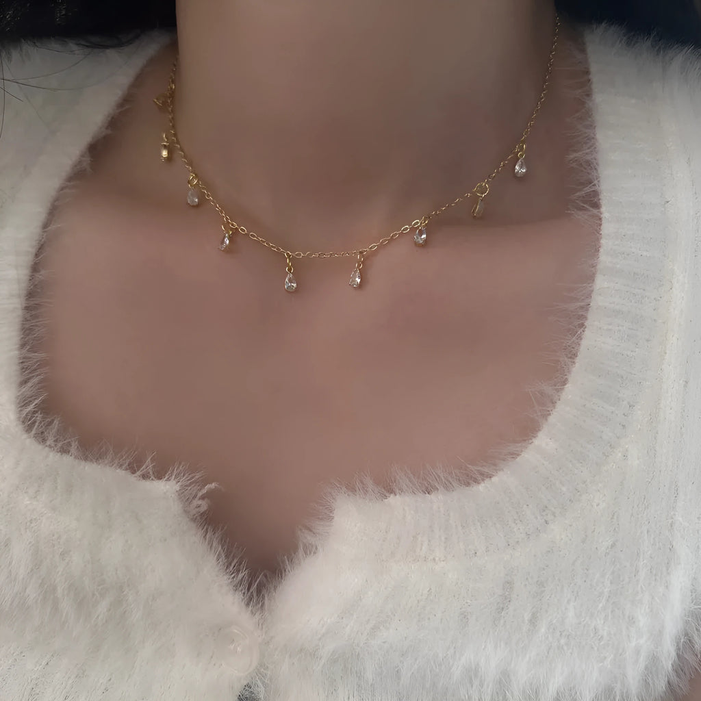 Women's zircon necklace, earrings, and anklet set with geometric pendant on a regular chain.