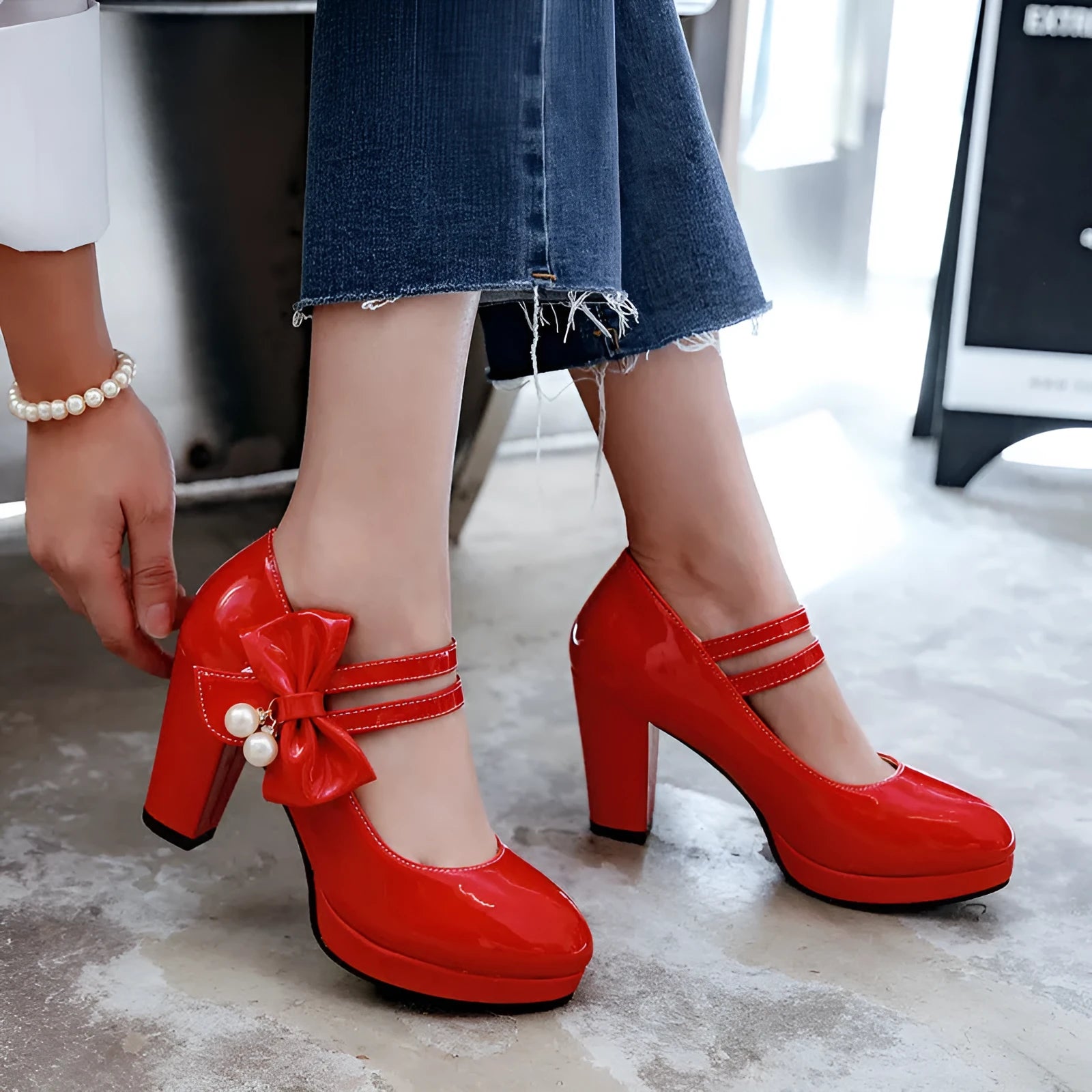 Red platform shoes with a thick chunky heel, round toe, and buckle fastening on a white background.