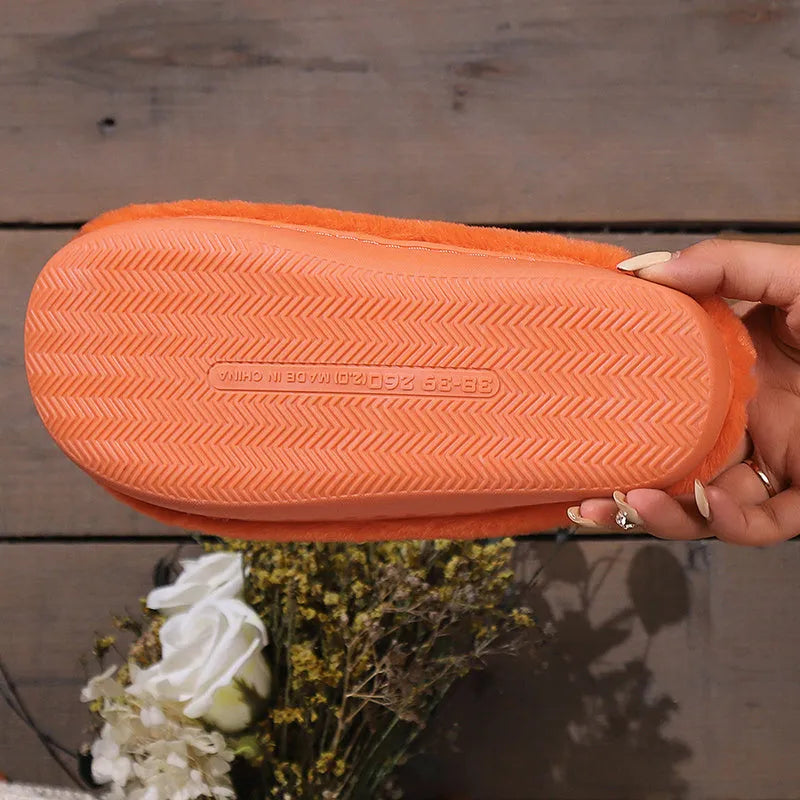 Orange women's Halloween pumpkin slippers with plush lining and a non-slip PVC sole