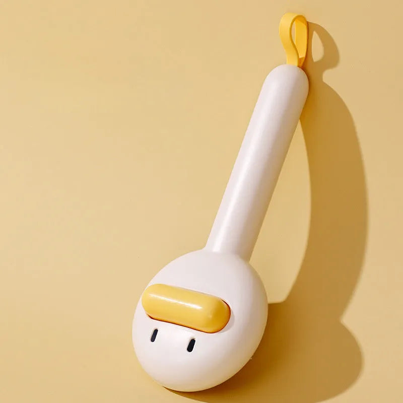 Small yellow duck-shaped pet grooming comb with needle tines for hair removal from cats and dogs.