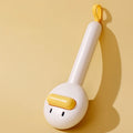 Small yellow duck-shaped pet grooming comb with needle tines for hair removal from cats and dogs.