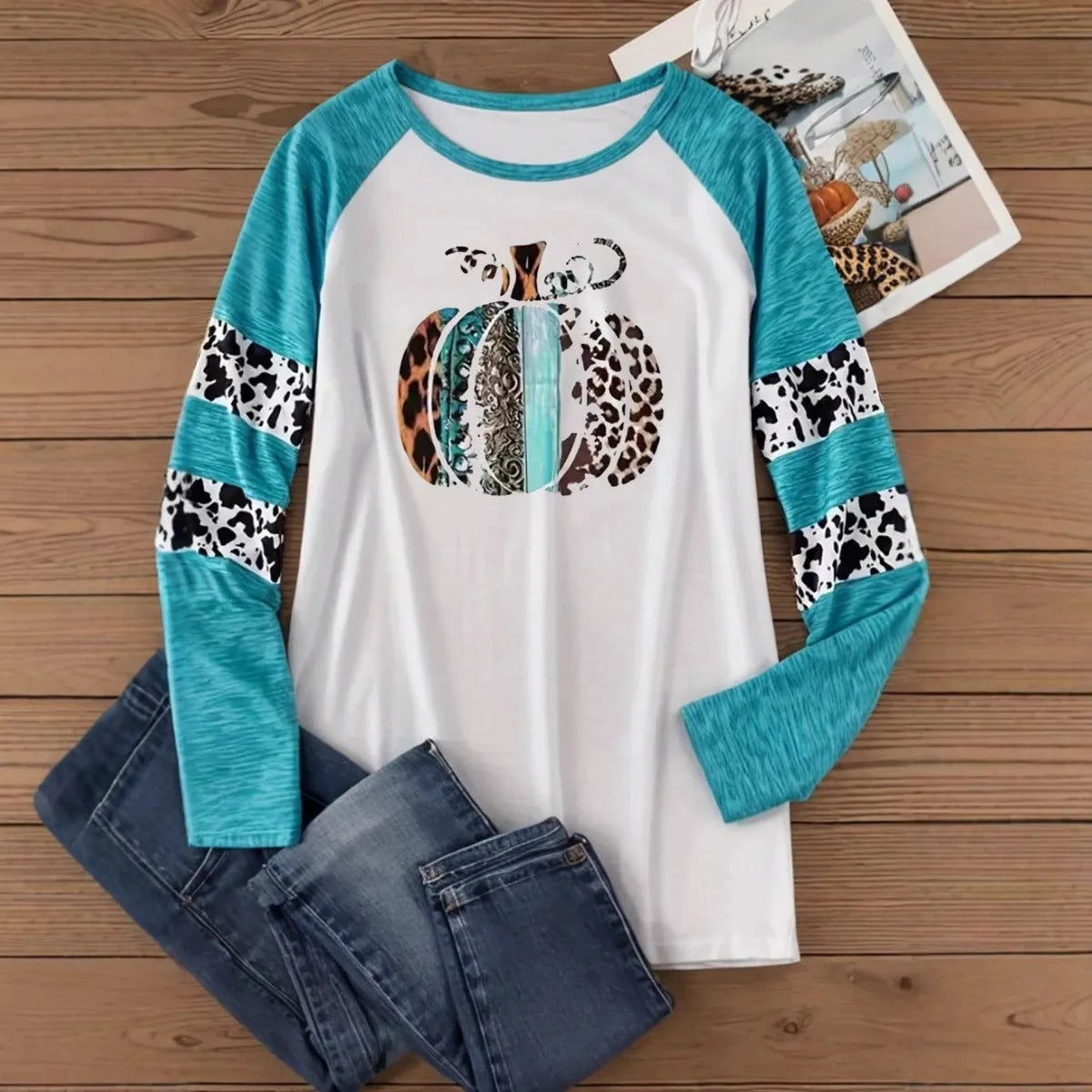 Sky blue long sleeve t-shirt with a white 3D digitally printed Halloween pumpkin graphic.
