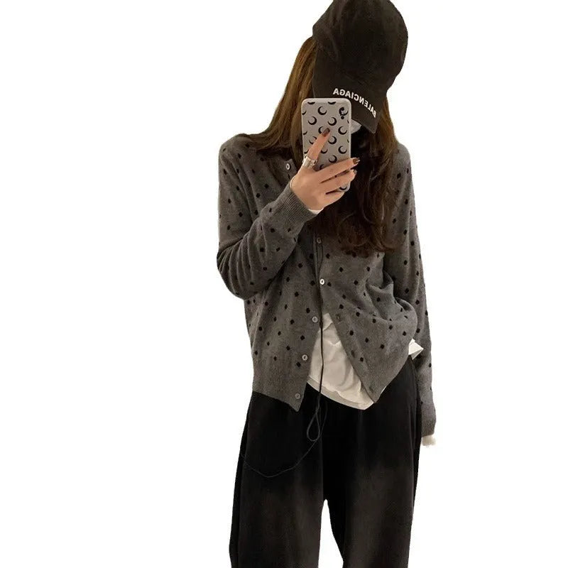 Women's grey dot pattern knitted cardigan with crocheted flower details on front