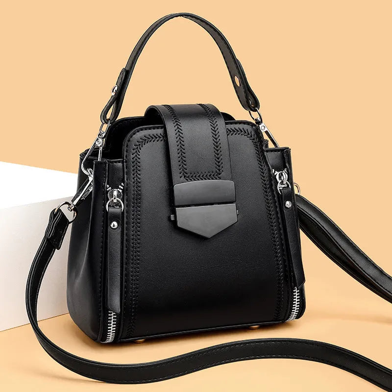 Small square vertical women's handbag in soft textured PU leather, shown in multiple colour options.