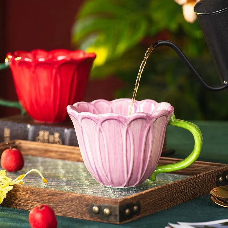 A red and purple floral ceramic cup with a 500ml capacity on a wooden table.