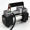 High power metal double cylinder 12V car air pump with battery clips and nozzle kit on black background