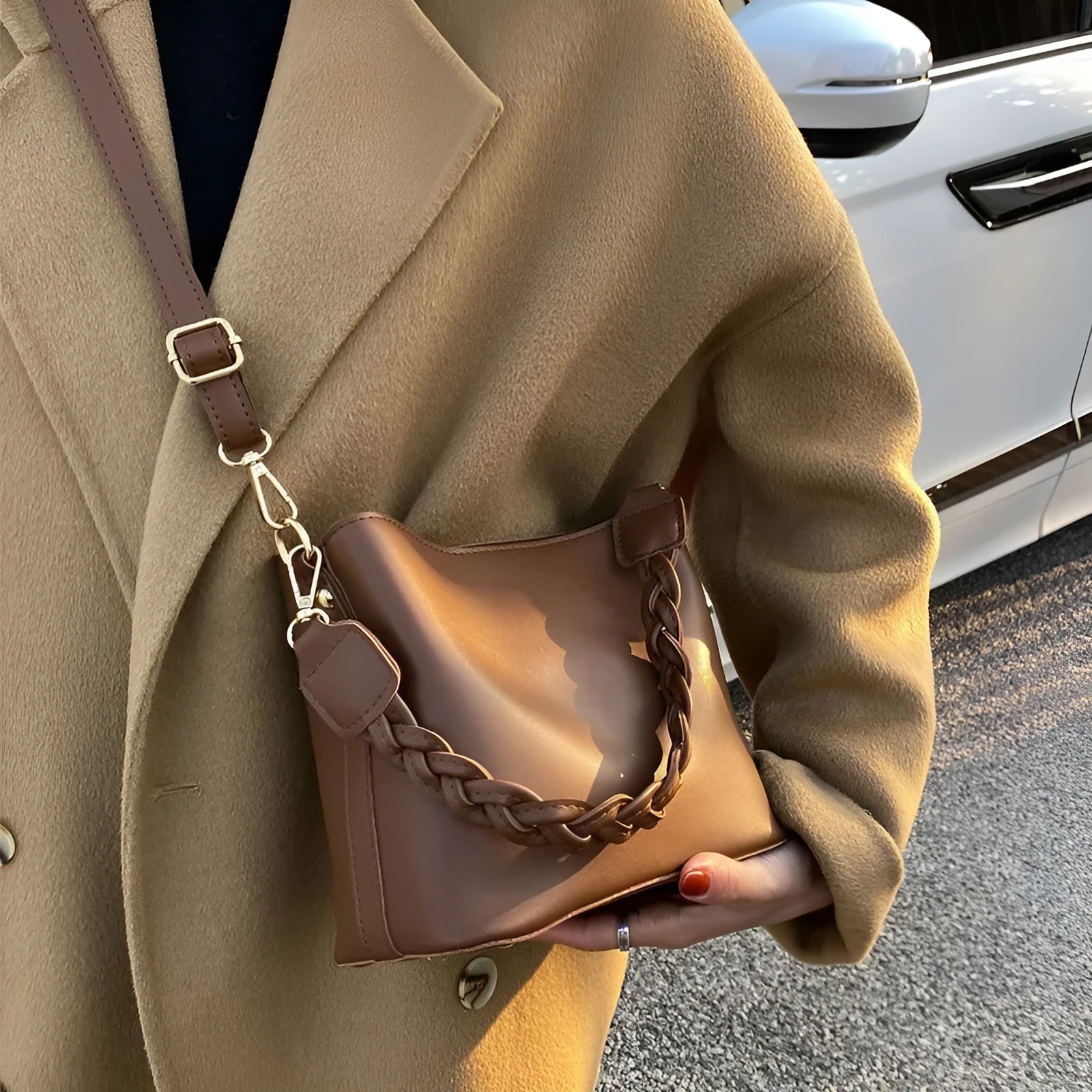 Retro style khaki woven PU leather crossbody bucket bag with an adjustable strap, shown in a casual setting.