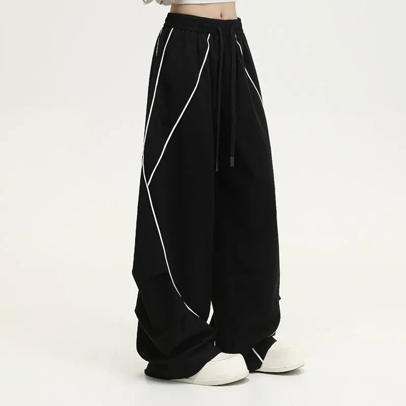 Black pleated wide-leg hip hop sports trousers with striped pattern and elasticated waist.