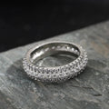 Triangular geometric ring with a zircon stone centre, shown in different metal plating colours.
