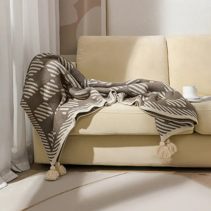 Bohemian-style acrylic knit sofa blanket with tassels in a geometric pattern