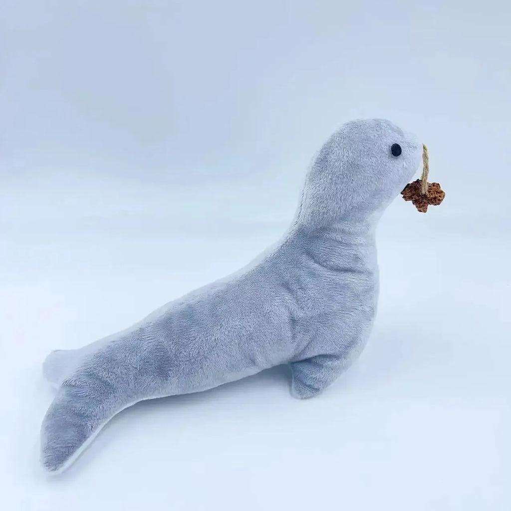 Blue sea lion plush cat toy with detailed stitching, shown alongside catnip filling and bell component