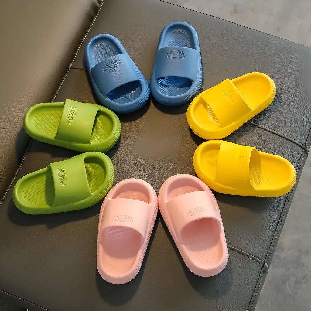 Children's mixed colour EVA slippers with textured sole, shown in blue, green, orange, pink, and yellow.